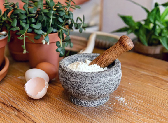 Crushed eggshell fertilizer being prepared for indoor plants.